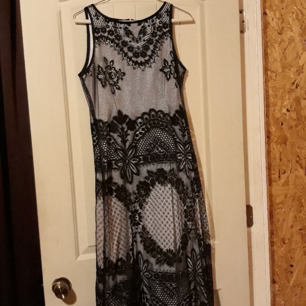Floor length white dress with black lace.